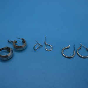 Three pairs of silver pierced earrings.